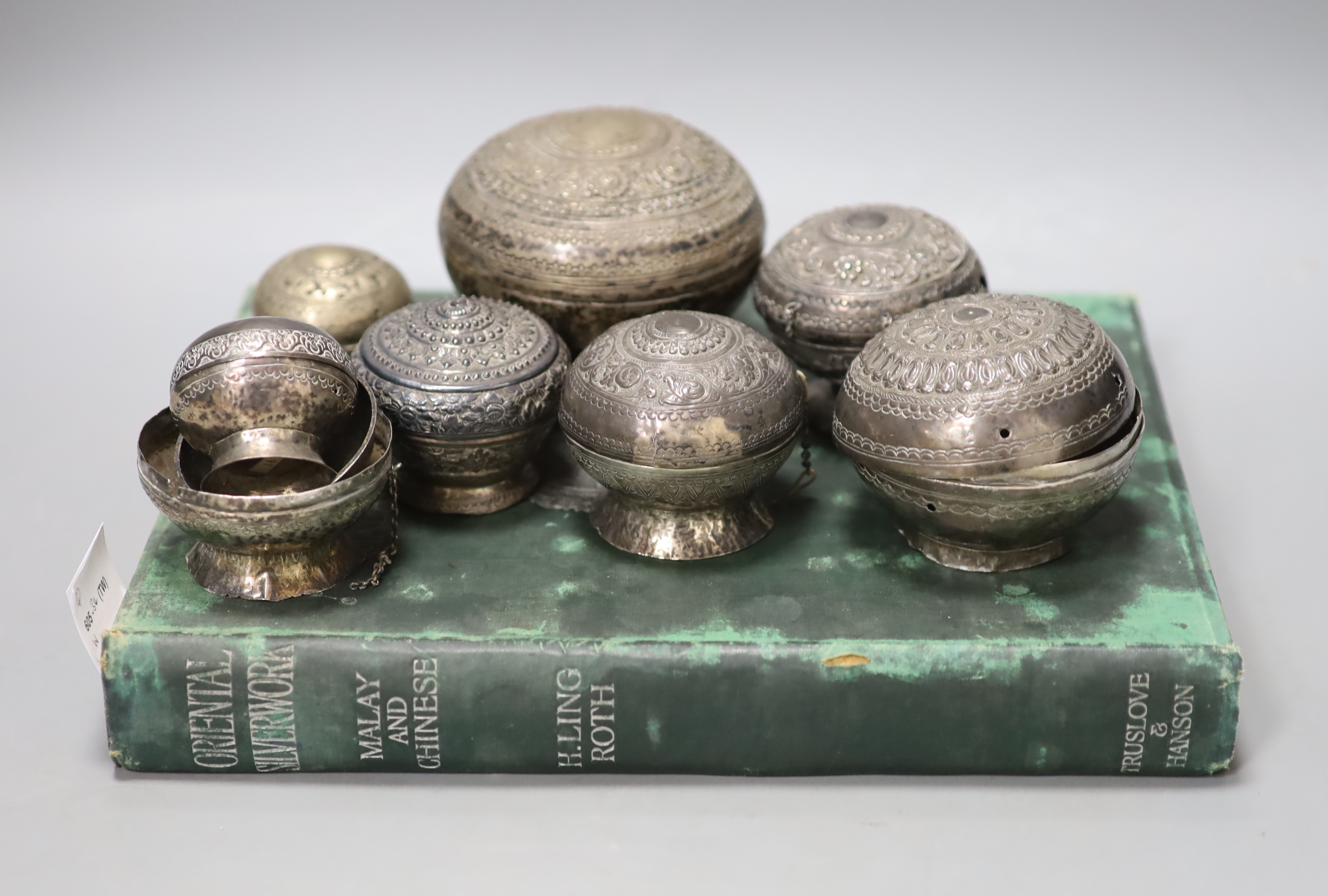 A collection of Malay Straits white metal circular betel nut boxes ('Chimbul'), Diameter 5cm to 10cm